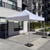 White 10x10 pop up tent with rubber weights set up on a modern apartment patio in Burnaby, BC